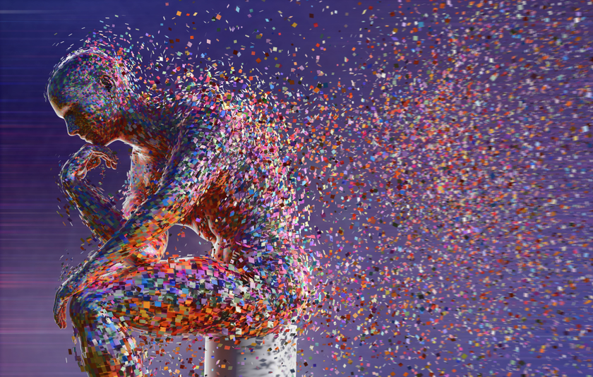 Künstliche Figur in Denkerpose, die aus bunten Teilchen zusammengesetzt ist