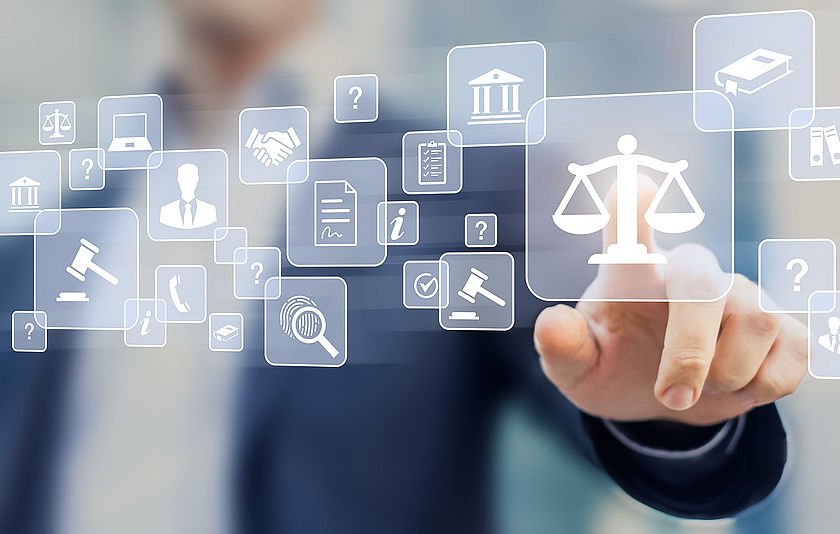 Eingeblendete Icons der Justiz, Finger zeigt auf das Icon einer Waage Eingeblendete Icons der Justiz, Finger zeigt auf das Icon einer Waage