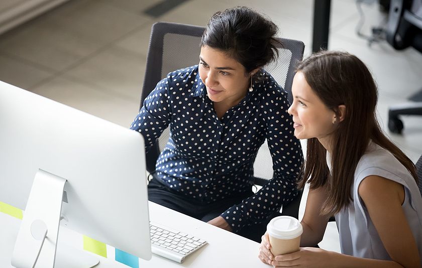 Zwei junge Frauen vor einem PC