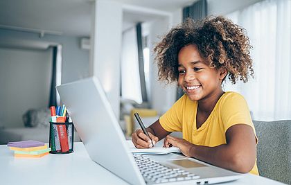 Grundschul-Schülerin vor dem Laptop beim Onlinelernen.