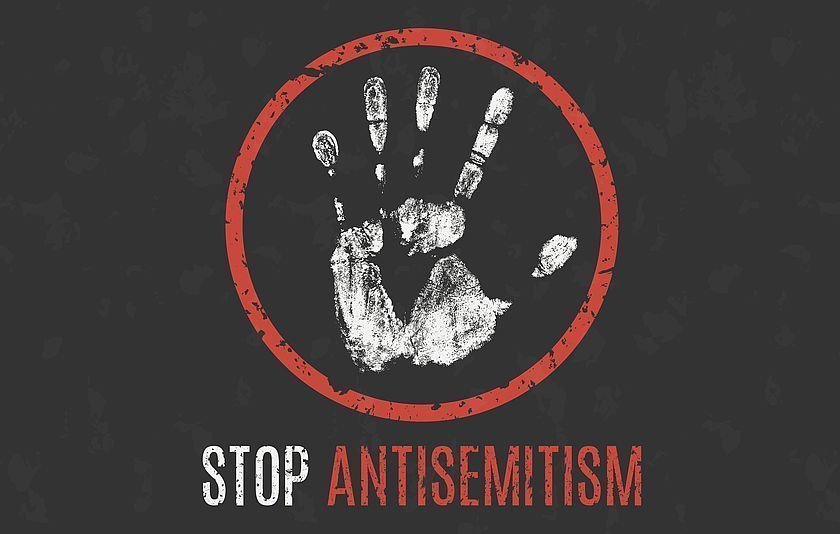 Weißer Handabdruck mit rotem rundem Rand mit der Aufschrift Stop Antisemitism