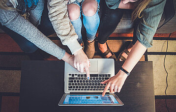 Menschen zeigen auf Computer