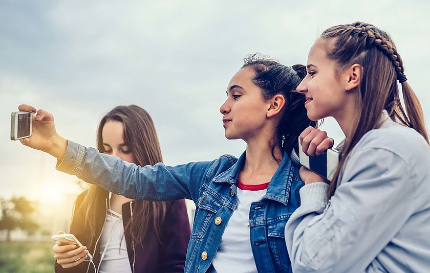 Drei Mädchen posen beim Selfie.